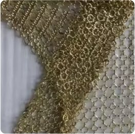 Draped stainless steel ring mesh curtain catching the light