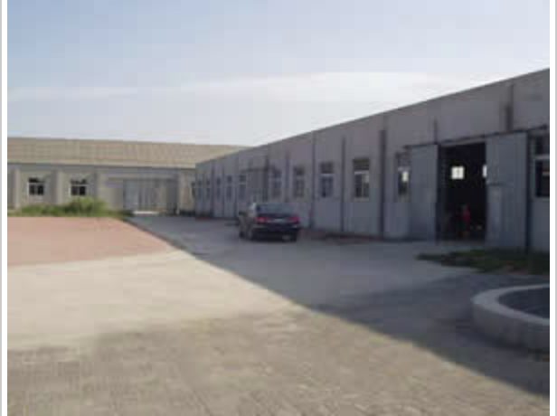 Single-storey production buildings around the concrete loading yard